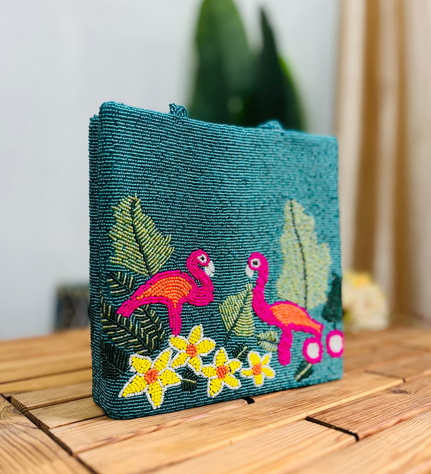 Colorful hand-beaded tote bag with flamingo pattern, featuring vibrant tropical leaves and flowers, by Zara Label.